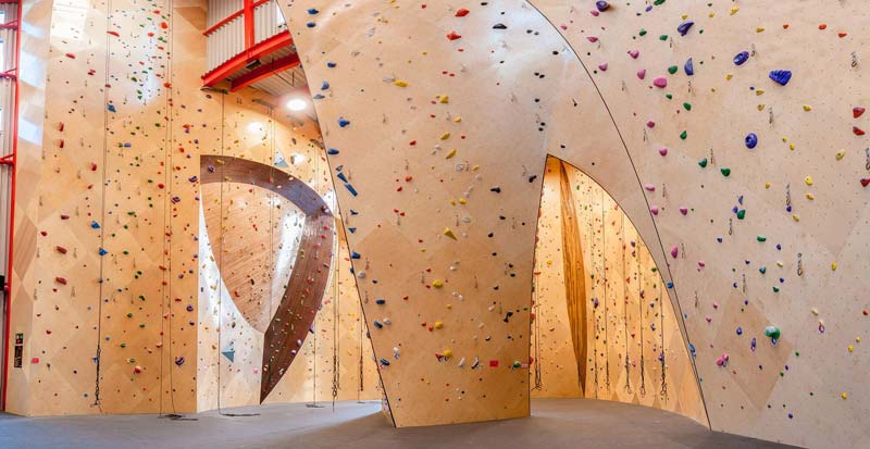 Picture of Front Climbing Club walls with tall wooden walls and asymmetric openings